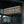 Handcrafted rectangular wood bead chandelier with natural finish, hanging near a window
