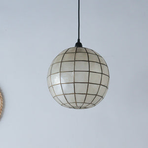 Handcrafted mother-of-pearl globe pendant light with grid design, perfect for boho or coastal home decor.