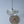 Handcrafted seashell pendant light with gold grid, paired with woven rattan wall decor for boho coastal style