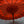 Traditional Balinese red parasol with intricate patterns and wooden pole