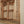 Hand-carved Balinese wooden window with intricate floral patterns and natural wood finish
