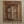 Hand-carved Balinese wooden window with intricate floral patterns on beige wall