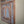 Hand-carved Balinese wooden window with intricate floral patterns and light blue accents