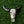 Hand-carved decorative buffalo skull with intricate Balinese patterns on green foliage background