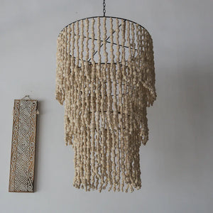 Handmade Balinese seashell chandelier with layered beads, boho wall art decor background