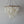Handmade seashell chandelier with layered rectangular shell pieces and a natural wood frame.