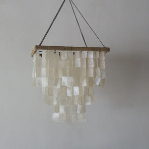 Handcrafted seashell chandelier with rectangular white shell pieces and woven details