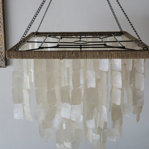 Handmade seashell chandelier with cascading white shell pieces and metal frame