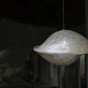 Eco-friendly handmade seashell pendant lamp with textured finish, hanging indoors
