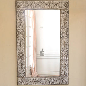 Hand-carved Balinese mirror with intricate geometric patterns, rustic wall decor