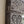 Close-up of hand-carved Balinese wood frame with intricate white swirl patterns