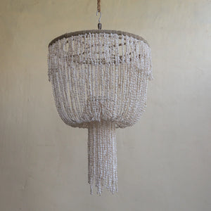 Handmade Balinese seashell chandelier with cascading white shell strands, boho home decor