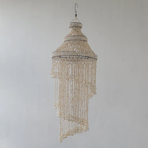 Handmade Balinese seashell chandelier with spiral design on a neutral background
