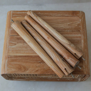Set of four natural wooden furniture legs on a rustic wood table, eco-friendly decor