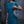 Woman holding Wire Mesh Hand Woven Bag Ratna while wearing a blue dress, showcasing the unique handwoven design.