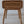 Hand-carved wooden side table with rattan drawer and intricate Balinese pattern.