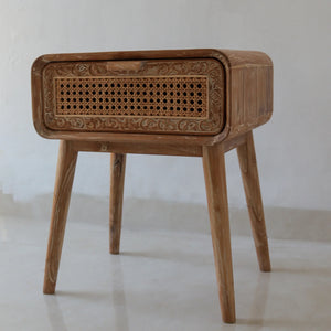 Hand-carved wooden nightstand with rattan drawer and ornate Bali-inspired details