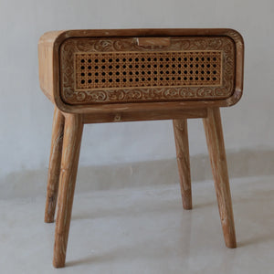 Hand-carved wooden nightstand with rattan drawer and intricate Balinese patterns