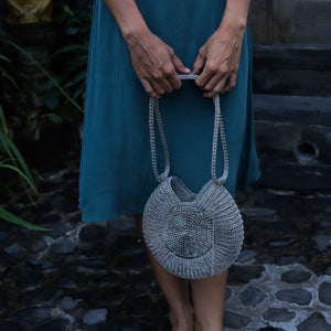 Wire Mesh Hand Woven Bag Ratna held by a person, showcasing the unique handwoven brass mesh design and eco-friendly style.