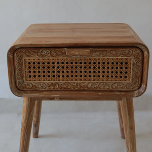 Hand-carved wooden nightstand with rattan drawer and intricate Balinese floral details