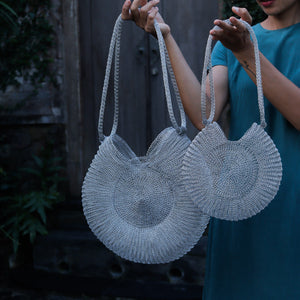 Wire Mesh Hand Woven Bag Ratna displayed in eco-friendly style with two handwoven brass bags.