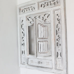 Hand-carved white Balinese wooden window with intricate floral detailing, wall-mounted decor