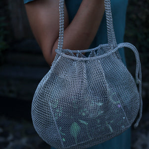Wire Mesh Hand Woven Bag Lily showcased in stylish eco-friendly design with vibrant floral accents.