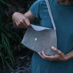 Wire Mesh Hand Woven Bag Melati being held, showcasing its unique handwoven design and eco-friendly material.