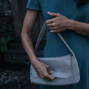 Wire Mesh Hand Woven Bag Melati showcased in a stylish hand, emphasizing its unique handcrafted design.