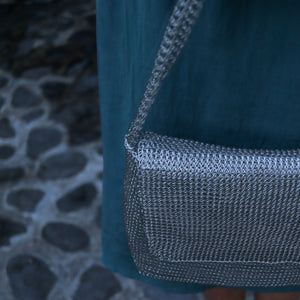 Wire Mesh Hand Woven Bag Melati showcased against a textured stone background.