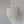 Three-tier seashell chandelier with natural rope, hanging against a plain wall.