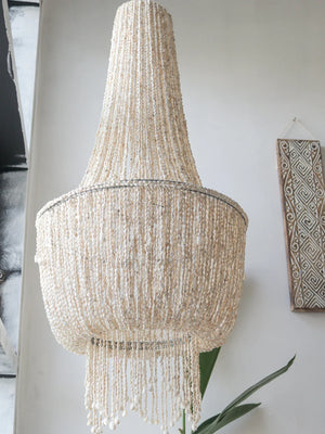 Handmade Balinese seashell chandelier with natural beads in a modern interior setting
