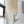 Handmade Balinese seashell chandelier hanging by a window in a bright, minimalist room