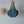 Blue beaded chandelier with natural rattan wall decor on a light grey wall
