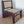 Teak wood lounge chair with woven rattan seat and backrest on a textured mat