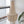 Handmade seashell chandelier with cascading beads in a modern interior by a window