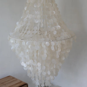 Handmade large capiz shell chandelier with cascading white discs in a modern interior