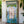 Hand-carved Balinese door with blue, green, and white ornate wood detailing.
