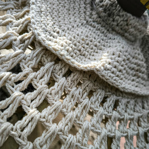 Close-up of handmade macrame wool parasol with intricate woven pattern