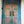 Hand-carved Balinese wooden door with floral patterns and distressed blue paint