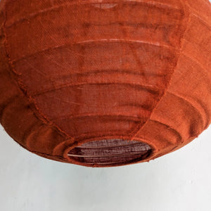 Handcrafted brown fabric pendant light with visible stitching, ideal for eco-friendly decor
