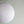 Large white paper lantern hanging against a plain light wall, minimalist home decor