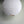 Large round white paper lantern pendant light against a pale green wall.
