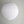 White round paper lantern hanging from ceiling against a plain wall, minimalist home decor
