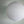 White round paper lantern hanging against a light grey wall, minimal modern decor