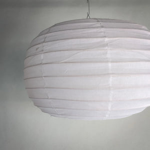 White paper lantern hanging on a plain wall, minimal modern home decor lighting
