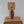 Handcrafted rattan table lamp with woven shade and wooden base on carved furniture