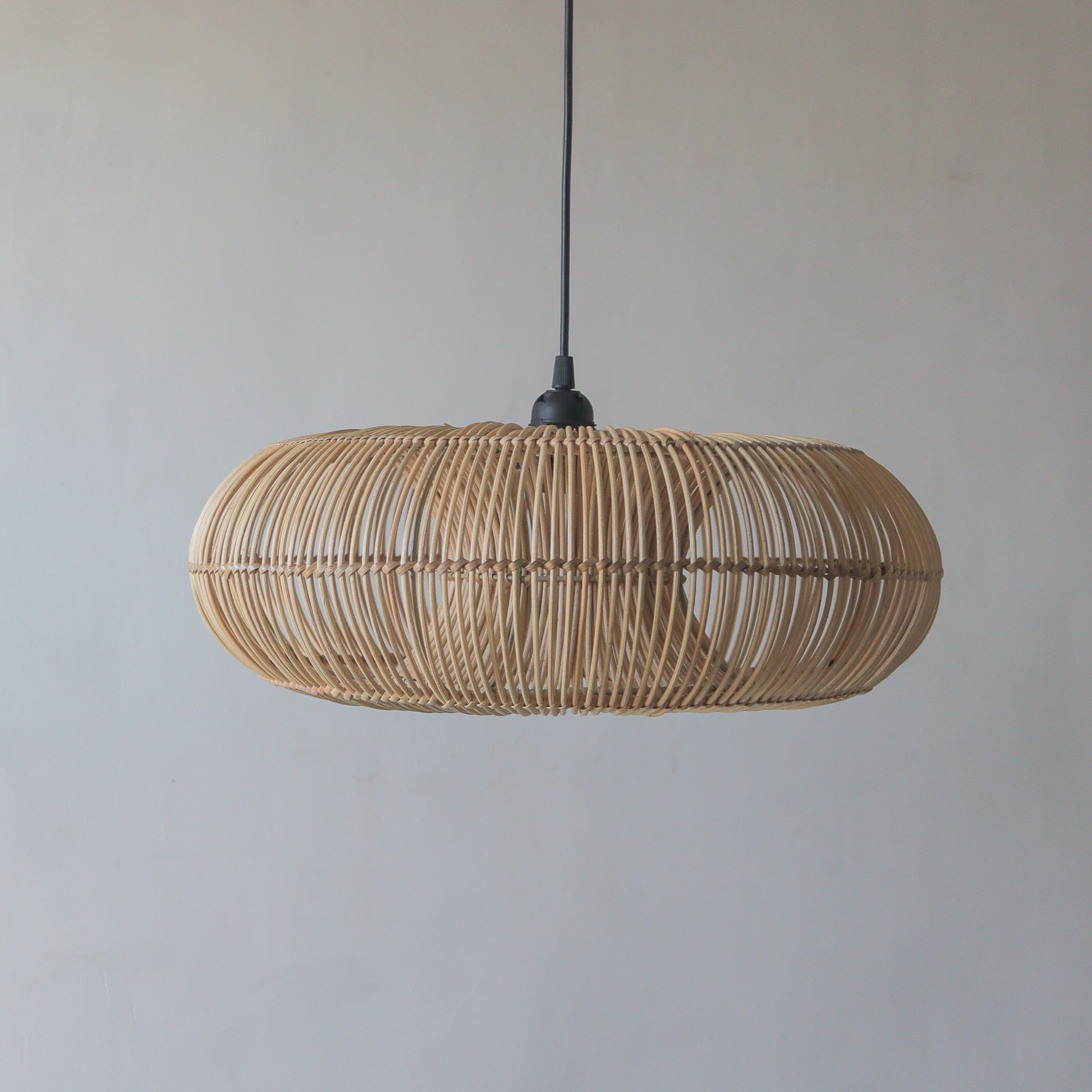 Handcrafted Rattan Pendant Light in Donut Design, unique decor from Bali, Indonesia, showcasing artisan craftsmanship.