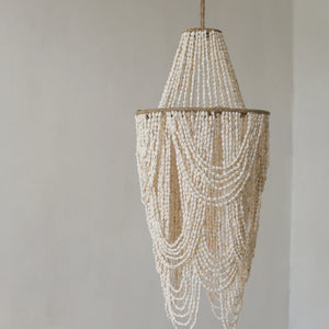 Handmade seashell ceiling light with cascading shell strands, coastal boho decor