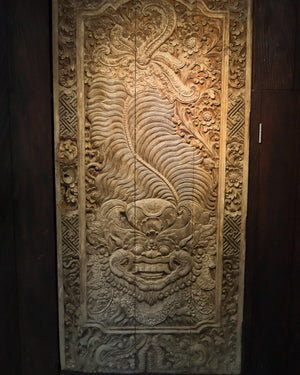 Hand-carved Balinese wooden wall panel with intricate floral and mythical motifs